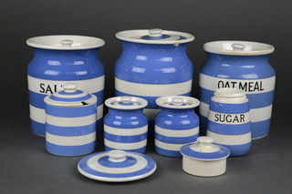 6 T G Green & Co blue and white storage jars comprising salt, oatmeal, 3 others, a sugar caster and 2 lids 