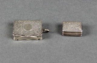 A Victorian silver rectangular vinaigrette with scroll decoration and vacant cartouche, Birmingham 1890, a small ditto 