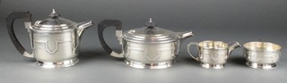 An Art Deco silver 4 piece tea and coffee set with strapwork decoration and ebony mounts, Sheffield 1937 and 1938, gross 1484 grams 