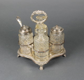 A silver plated quatrefoil condiment stand with 4 later cut glass bottles, 2 silver silver mounts 