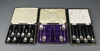 A cased set of 8 reproduction apostle spoons, London 1938, 68 grams, a cased set of 6 slipped in a stork silver spoons, London 1939 56 grams and a cased set of 4 silver teaspoons and nips, Birmingham 1910 