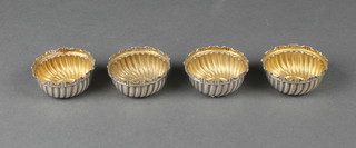 A set of 4 Victorian repousse silver table salts with spiral fluted decoration, London 1892, 52 grams