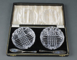 A pair of cut glass silver butter dishes with silver knives 