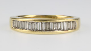 An 18ct gold baguette diamond half hoop ring, size N
