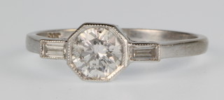 An 18ct white gold single stone diamond ring, approx. 0.75ct with baguette shoulders, size O 1/2
