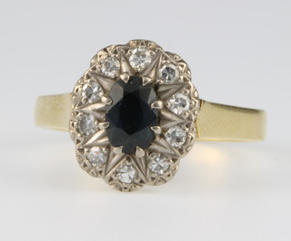 An 18ct yellow gold oval sapphire and diamond cluster ring, the sapphire approx 0.5ct surrounded by 10 diamonds, size M 