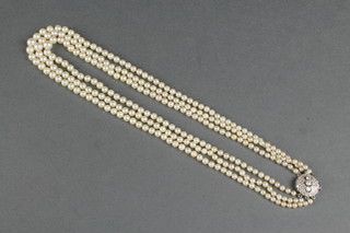 A cultured pearl 3 strand necklace with a diamond set open clasp 18 1/2" 
