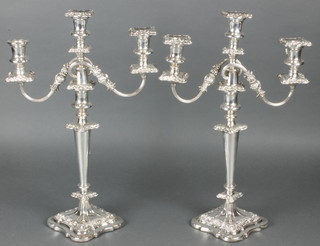 A pair of 3 light silver plated candelabrum with repousse decoration 18" 
