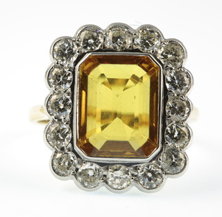 An 18ct yellow gold, yellow sapphire and diamond cluster ring, the rectangular centre stone approx 6ct surrounded by 16 brilliant cut diamonds approx 1.4ct, size P 1/2 