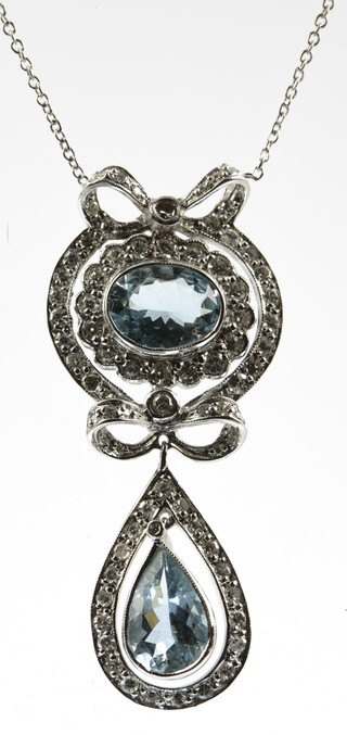 A white gold aquamarine and diamond Edwardian style drop pendant, set with an oval and pear cut centre stone approx 3ct surrounded by brilliant cut diamonds 
