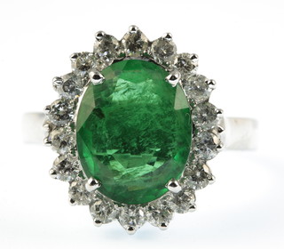 A 14ct white gold emerald and diamond oval cluster ring, the centre stone approx 3.6ct surrounded by 18 brilliant cut diamonds, approx. 0.8ct, size P 