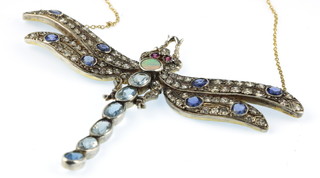 An 18ct yellow gold diamond, ruby, opal, aquamarine and sapphire set dragonfly pendant on a gold chain 