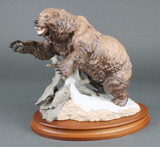 A Franklin Mint figure of a grizzly on a wooden base 10" 