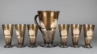 An amber glass lemonade set decorated with a galleon comprising a tapered jug 11" and 6 tapered glasses 6 1/2" 