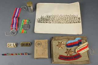 World War Two group, 1939-45 and Africa Star, Defence and British War medal, minor brass and cloth badges, a photograph  