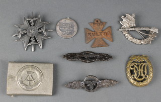A small collection of Second World War and other badges including a buckle etc 