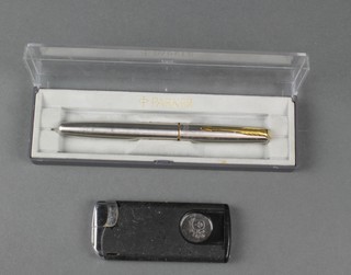A cased Parker fountain pen, a Colibri cigar cutter and lighter 