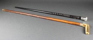 A carved ebony walking cane with plated knop and a horn handled walking cane