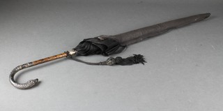 A silver handled parasol with heron handle 