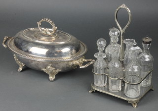 An Edwardian silver plated breakfast dish and cover, a 6 bottle cruet set