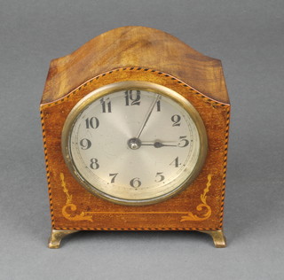A 1930's Art Deco bedroom timepiece with silvered dial and Arabic numerals contained in an arched inlaid mahogany case 