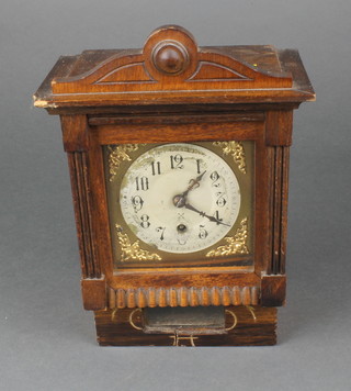 A mantel timepiece with gilt dial, silvered chapter ring and Arabic numerals contained in an oak case 
