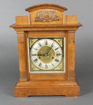 A 19th Century Continental bracket clock with square brass dial, silver chapter ring and Arabic numerals contained in an oak case by the Hamburg American Clock Co. 