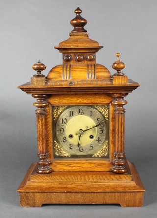 A 19th Century Continental bracket clock with square brass dial, silvered chapter ring and Arabic numerals contained in a light oak case 