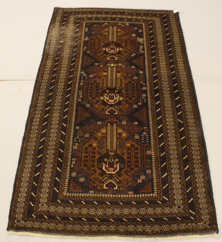 A brown ground Belouche rug 79 1/2" x 44" 