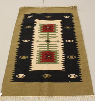 A tan and black ground Kelim rug 71" x 47" 