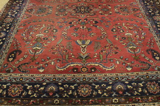 A pink ground and floral patterned Persian rug with all-over floral design, some moth 105"w x 134" 