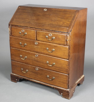 A Georgian oak bureau, the fall front revealing a well fitted interior above 2 short and 3 long drawers with brass swan neck drop handles, raised on bracket feet 42 1/2"h x 36 1/2"w x 18 1/2"d 