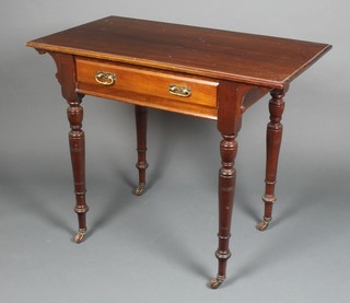 An Edwardian Art Nouveau walnut side table, fitted 1 long drawer with brass drop handles, raised on turned supports 29"h x 35"w x 19 1/2"d