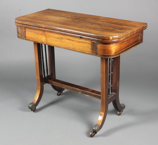 A 19th Century D shaped rosewood card table inlaid satinwood stringing, raised on standard end supports united by an H framed stretcher 29 1/2"h x 36"w x 17 1/2"d