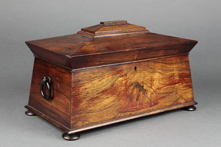 A 19th Century mahogany sarcophagus shaped twin compartment tea caddy, fitted two caddies, missing mixing bowl and having ring drop handles to the sides, raised on bun feet 7"h x 14"w x 8"d 