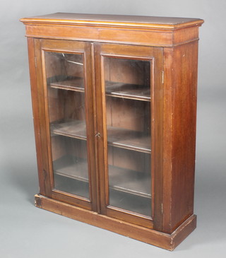 A Victorian mahogany bookcase/display cabinet, the interior fitted adjustable shelves enclosed by glazed panelled doors and raised on a platform base 42"h x 35"w x 12"d 