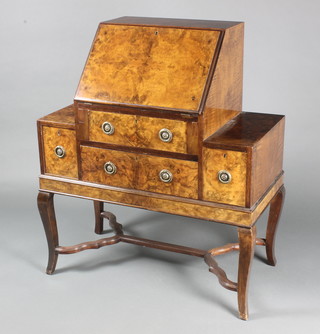 An Art Deco figured walnut bureau, the fall front revealing a well fitted interior above 2 long and 2 short drawers, raised on cabriole supports with wavy stretcher 40"h x 35"w x 17"d 