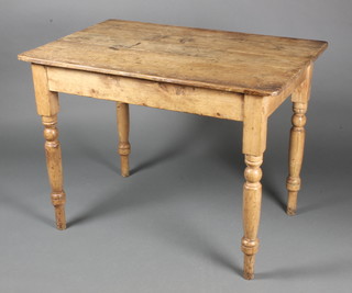 A Victorian rectangular pine kitchen table with 3 plank top, fitted a frieze drawer, raised on turned supports 29 1/2"h x 39"l x 26"w