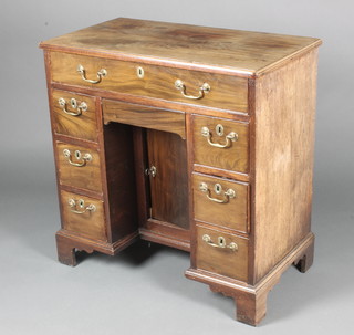 A Georgian mahogany kneehole pedestal dressing table fitted 1 long drawer above 6 short drawers, the pedestal fitted a secret drawer above a cupboard with brass swan neck drop handles, raised on bracket feet 33"h x 32"w x 17"d 