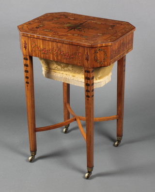 An Edwardian painted satinwood lozenge shaped work table, the top painted musical trophies and swags, the base fitted a drawer and deep basket, raised on square tapering supports, brass caps and casters 27"h x 20"w x 15 1/2"d