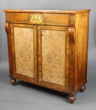 A Regency rosewood and inlaid brass chiffonier, with scroll decoration to the sides, the interior enclosed by panelled doors, raised on reeded bun feet 35"h x 33" x 15" 