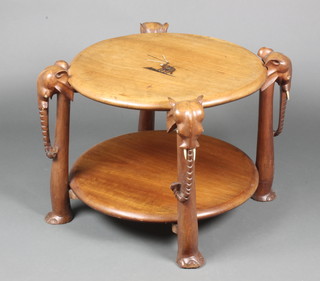 A 1930's circular teak 2 tier coffee table, raised on elephant supports 19"h x 23" diam. 