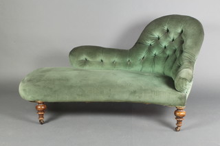 A Victorian shaped chaise longue, raised on turned supports upholstered in green buttoned material, 30"h x 53" x 27"d 