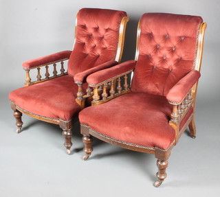 A pair of Victorian mahogany show frame library chairs upholstered in red and buttoned Dralon on turned supports 