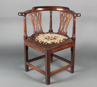 A Georgian mahogany corner chair with pierced slat back, upholstered drop in seat and a box framed stretcher 