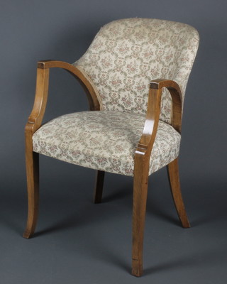 An Art Deco oak open arm chair upholstered in tapestry material on cabriole supports