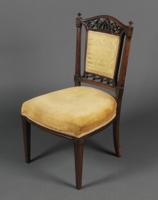 An Edwardian rosewood bedroom chair with arched back and pierced cresting rail, having an upholstered seat and raised on turned supports 