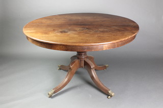 A Georgian mahogany circular snap top breakfast table, raised on turned column tripod base, brass caps and casters 28 1/2"h x 45" diam. 