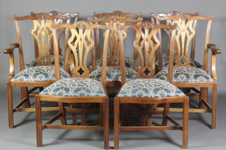 A set of 8 Chippendale style dining chairs of serpentine outline with upholstered drop in seats, raised on square tapering supports united by an H framed stretcher, 2 carvers, 6 standard 