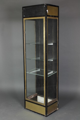 A gilt and ebonised metal rectangular display cabinet fitted shelves enclosed by a glazed panelled door 72"h x 20"w x 14"h